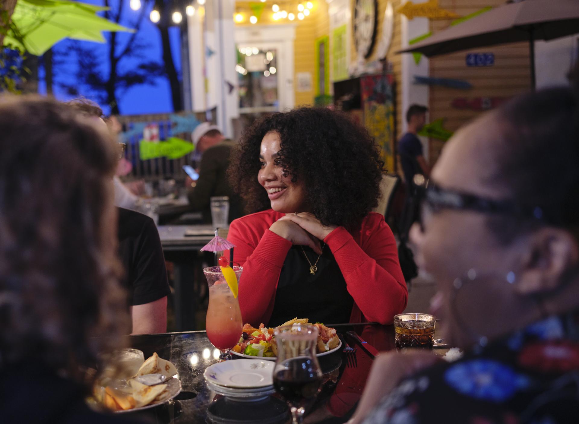 Group of people smiling at a table in a restaurant