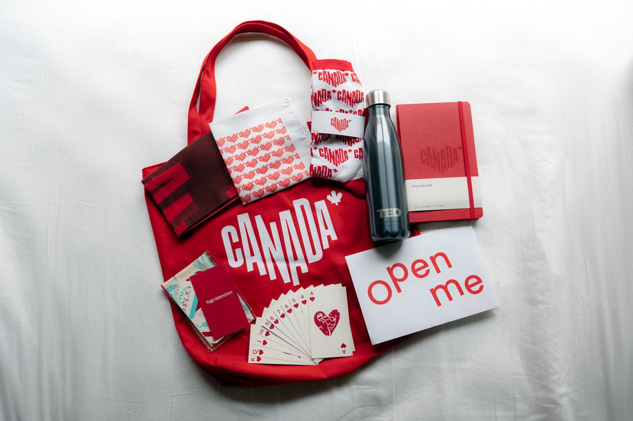 Destination Canada branded items including a tote, bottle, deck of cards, socks, and planner